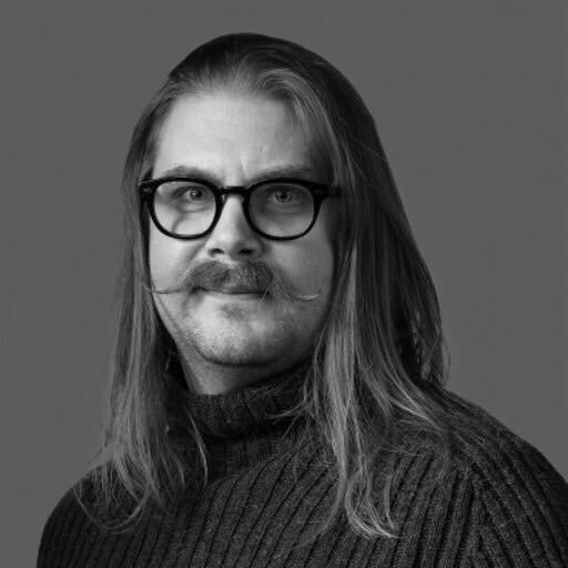 Long haired male
with glasses and manicured moustache